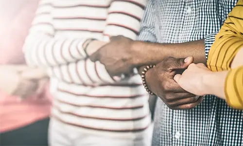 People holding hands side by side People holding hands side by side
